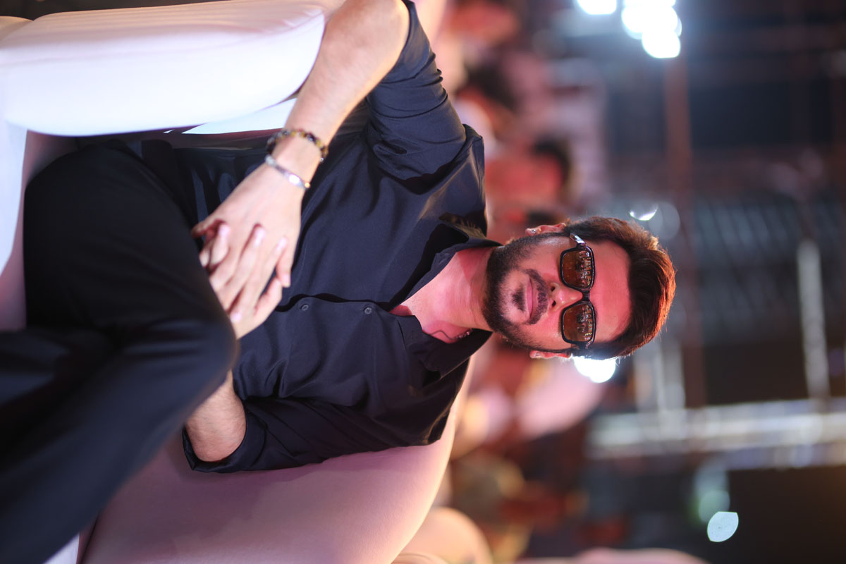 Divyendu Sharma seated during Peddi movie promotional event.