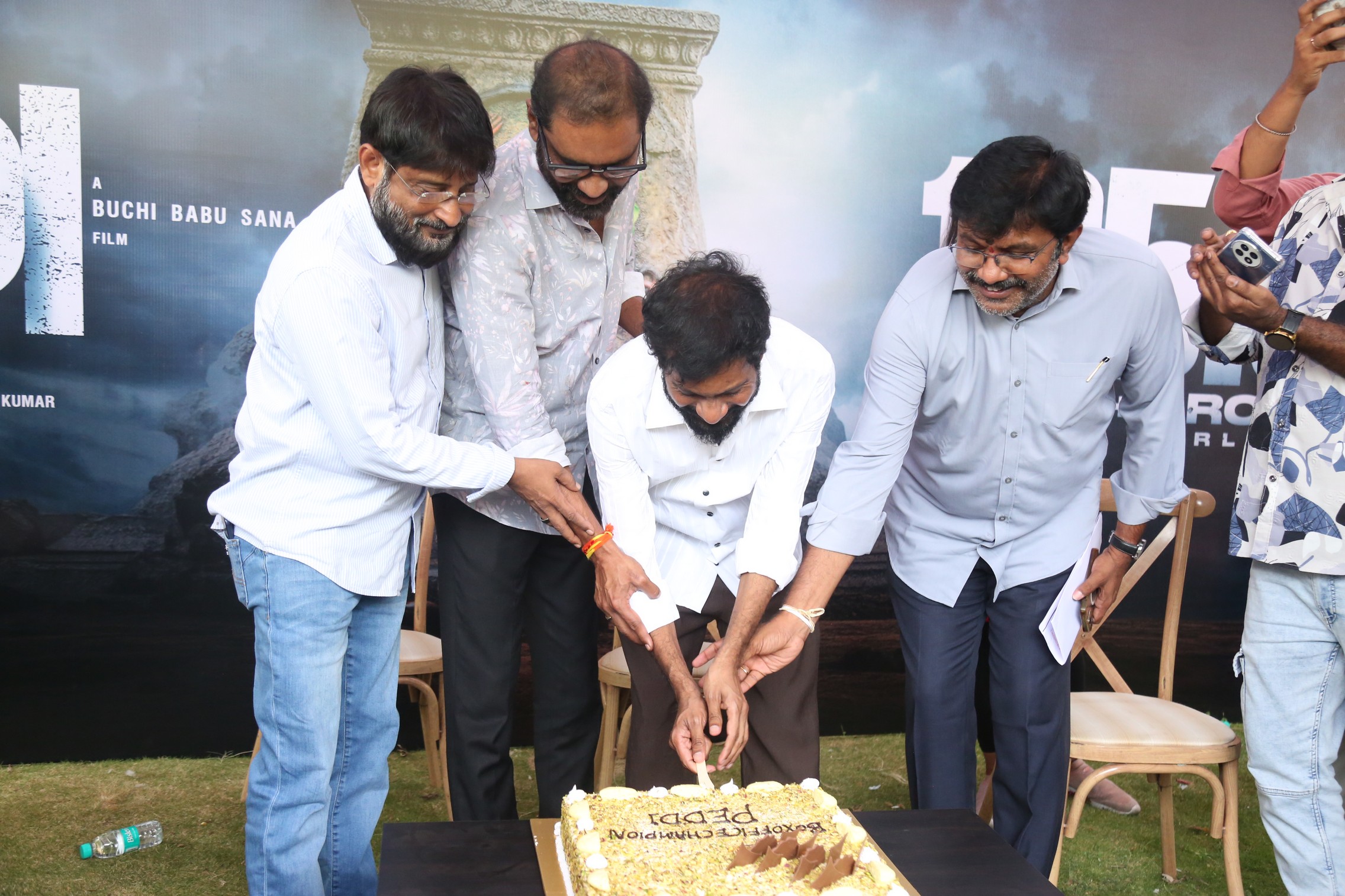 Peddi team cutting celebration cake