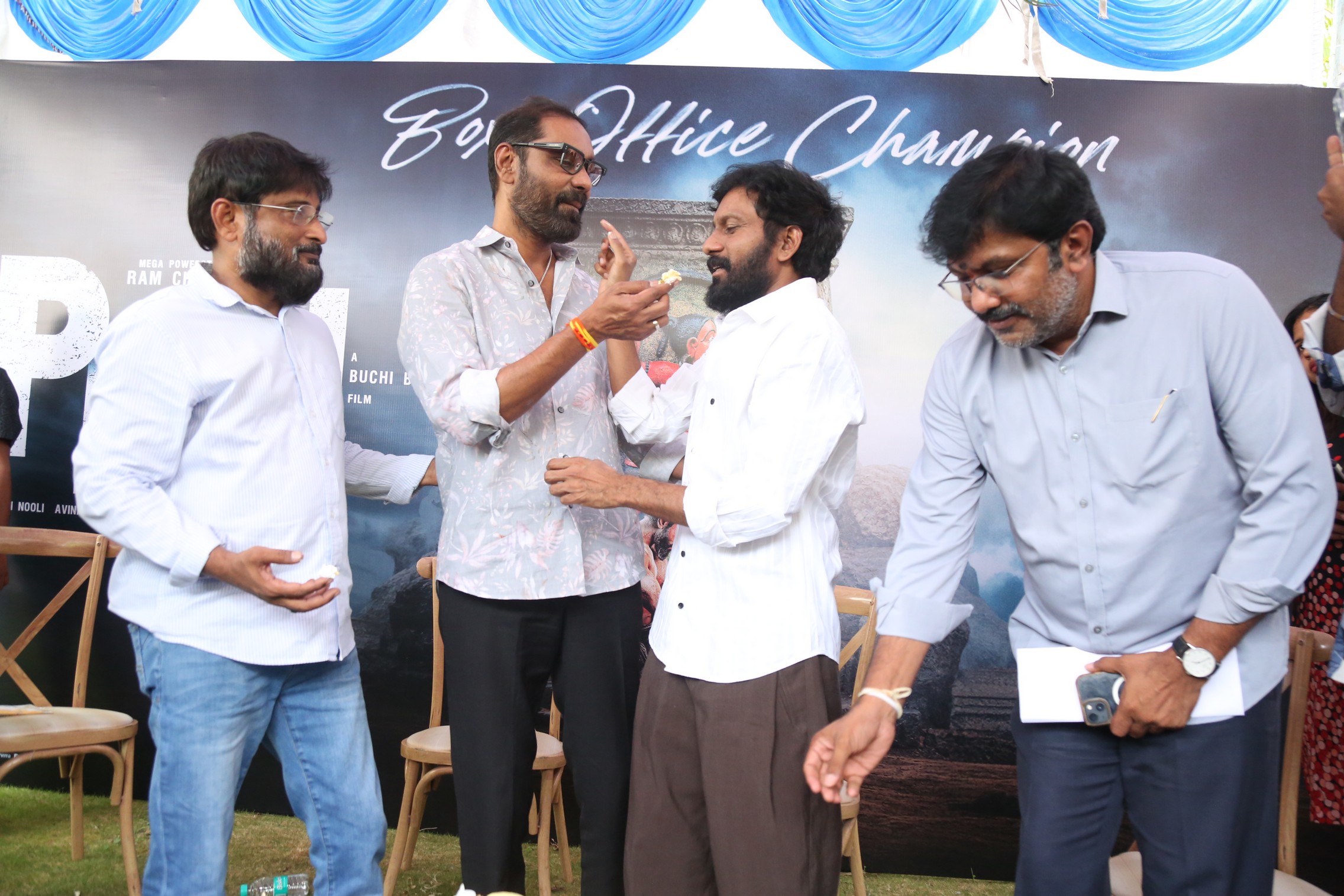 Peddi team sharing cake celebration