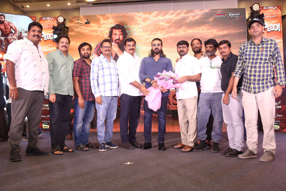 Peddi team with Ram Charan at event