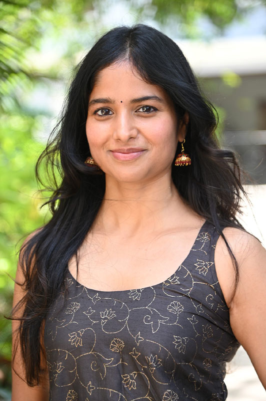 Shalini Kondepudi wearing an embroidered dress with elegant detailing during an outdoor photoshoot.