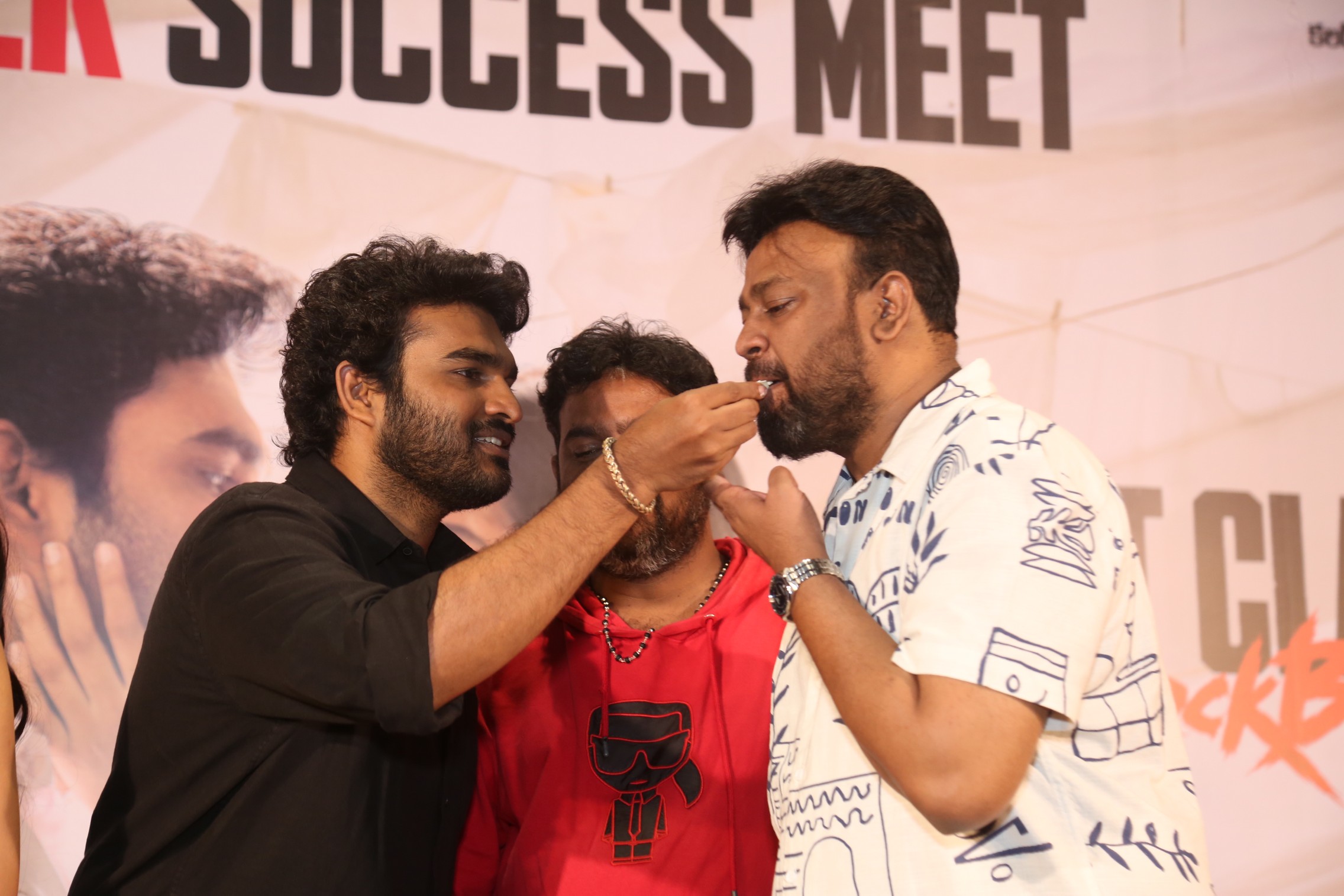 Kiran Abbavaraam feeding cake to producer Sai Rajesh