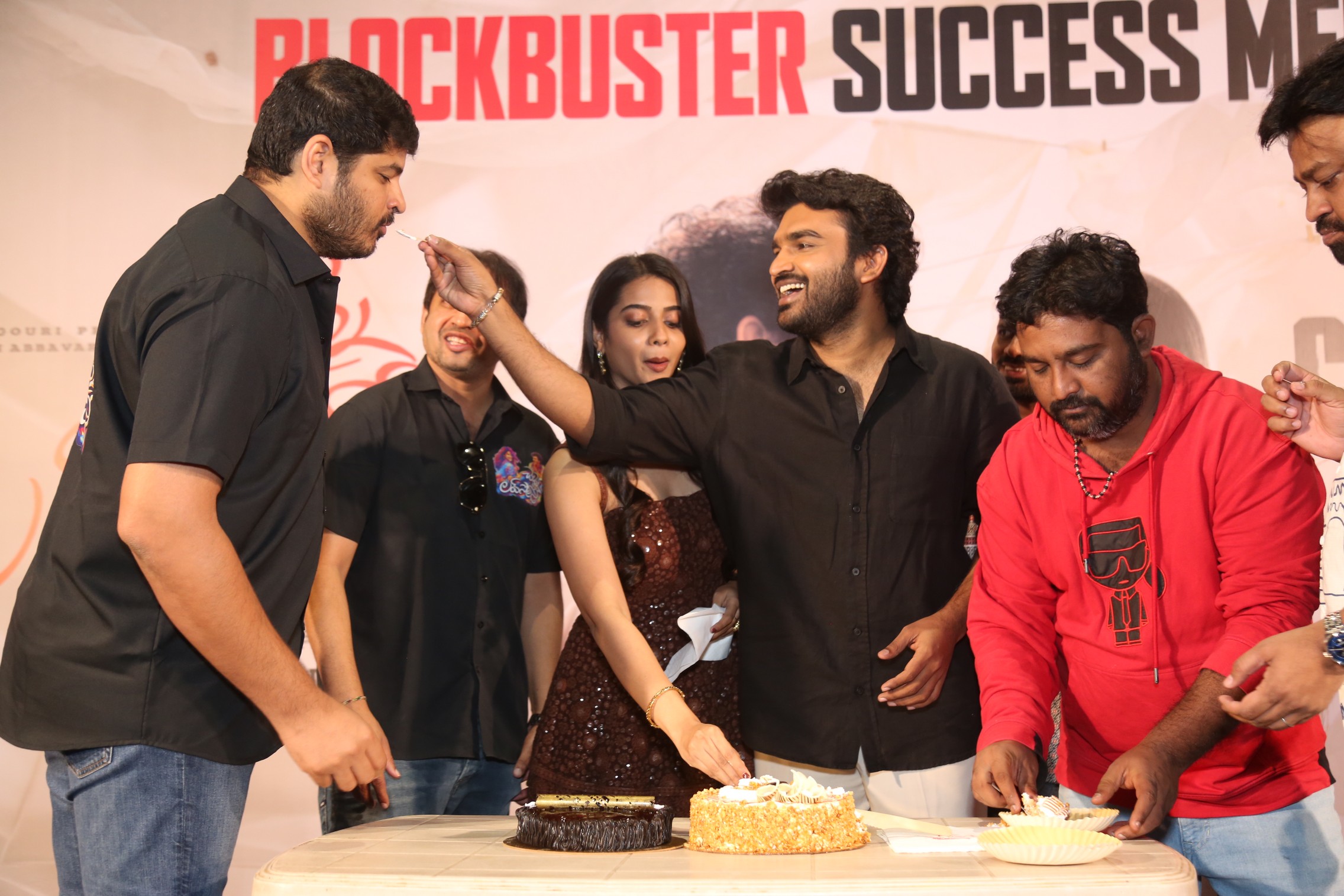 Kiran Abbavaraam feeding cake to Dheeraj Mogilineni at success meet
