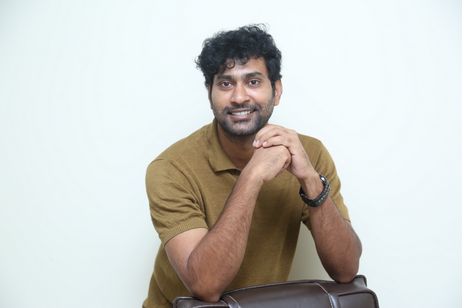 Thiruveer smiling in casual polo shirt