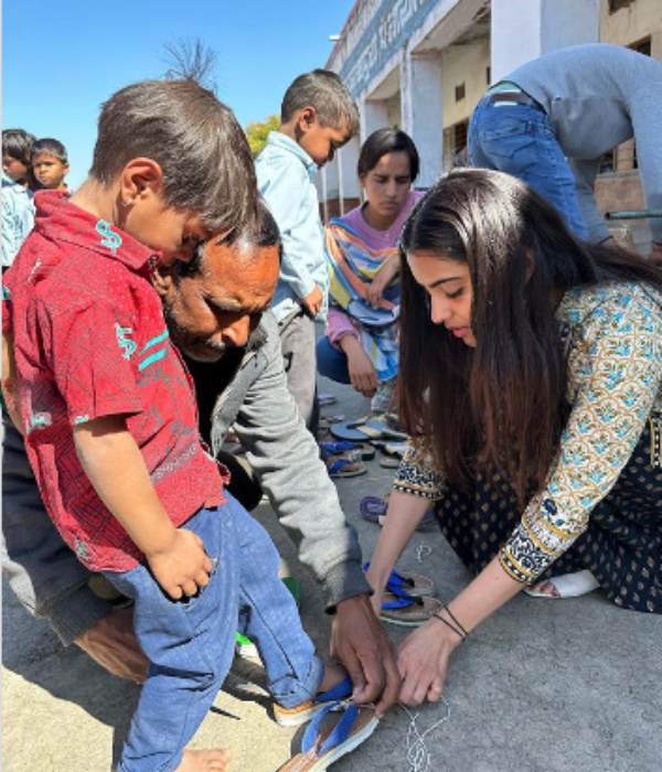 Malavika Sharma gives slippers and school bags to kids Malavika Sharma gives slippers and school bags to kids