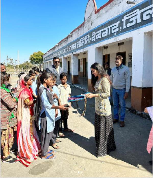 Malavika Sharma gives slippers and school bags to kids Malavika Sharma gives slippers and school bags to kids