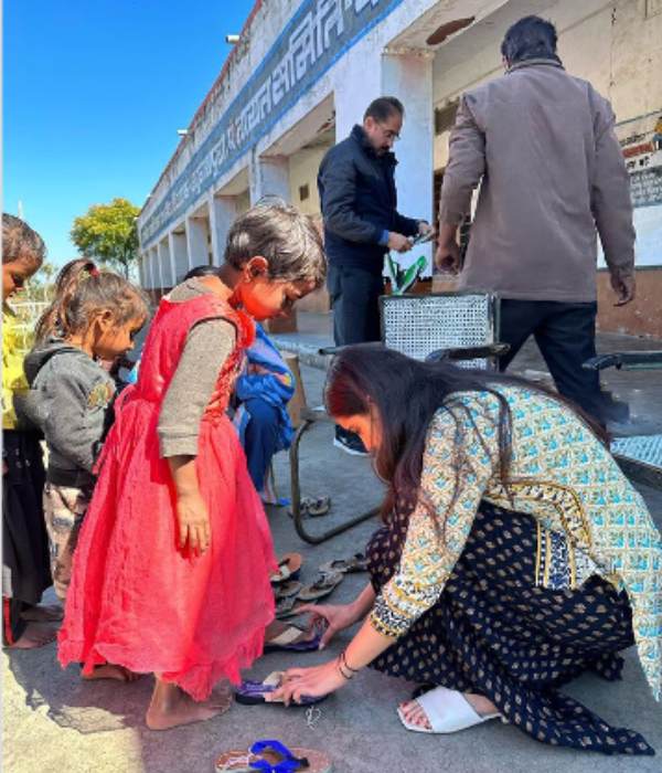 Malavika Sharma gives slippers and school bags to kids Malavika Sharma gives slippers and school bags to kids
