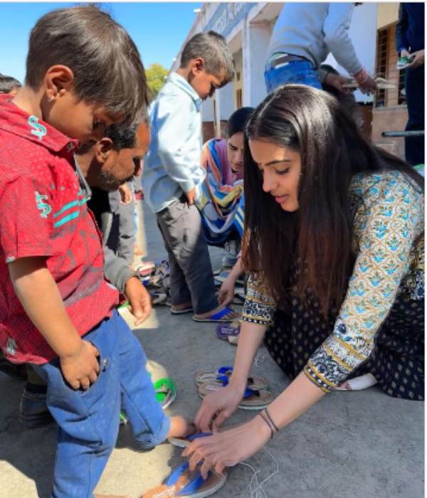 Malavika Sharma gives slippers and school bags to kids Malavika Sharma gives slippers and school bags to kids