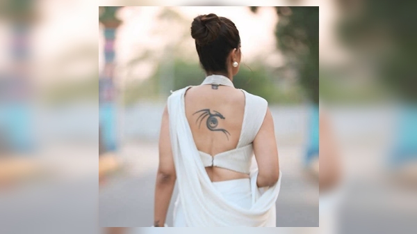 Varalakshmi s photo with a dragon tattoo on her back is trending