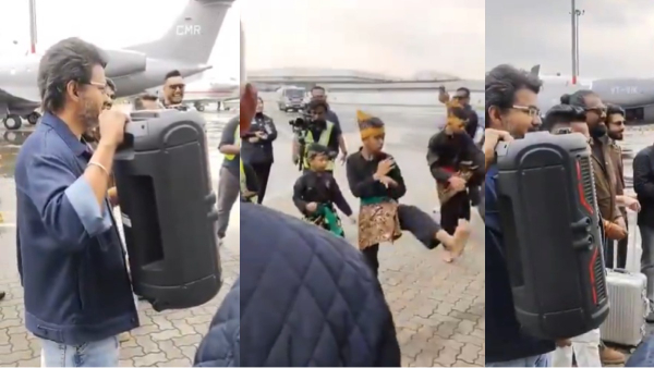 Vijay holding a speaker at Malaysia Airport vows fans