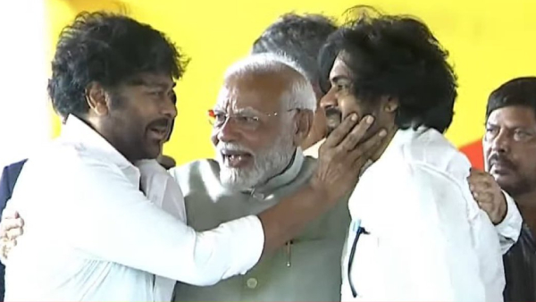 pm narendra modi greets and hugs chiranjeevi and pawan kalyan on the stage of swearing in ceremony