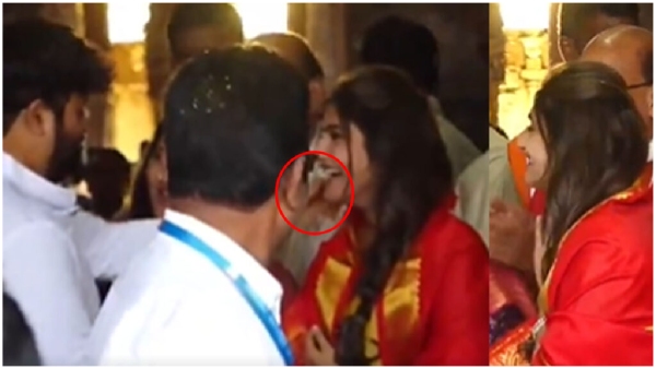SS Thaman rub Sreeleela cheek in Tirumala Temple Netizens trolls heavily