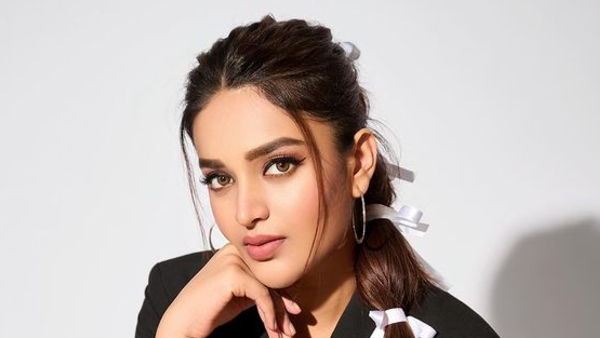 Nidhhi Agerwal PhotoShoot with deep neck blouse and lehenga Her latest photos here