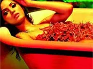 Neetu plunges into a tub of red chillies!